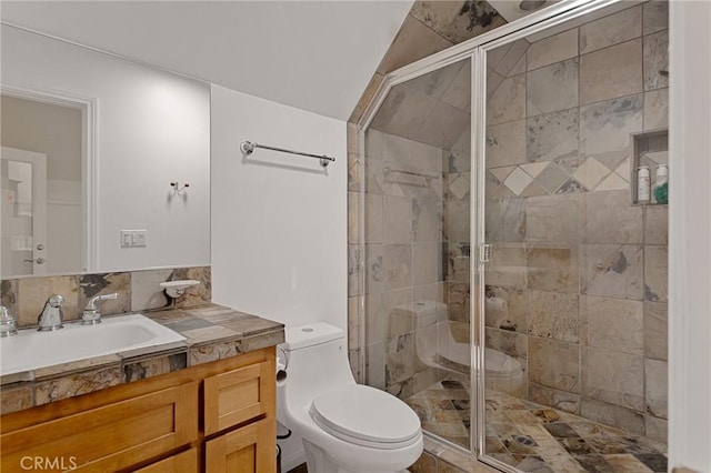 bathroom with toilet, lofted ceiling, walk in shower, and vanity