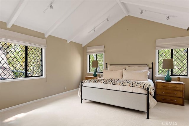 carpeted bedroom with lofted ceiling with beams and multiple windows