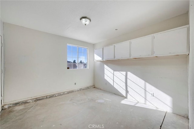 spare room with concrete flooring