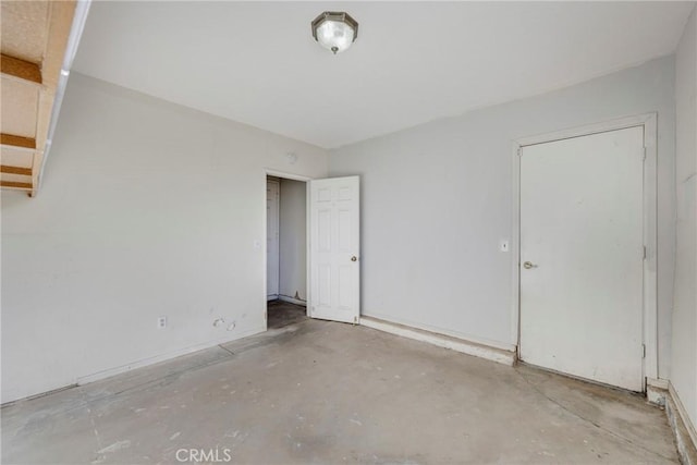 unfurnished room featuring unfinished concrete flooring