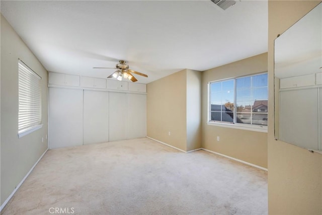 empty room with light carpet and ceiling fan