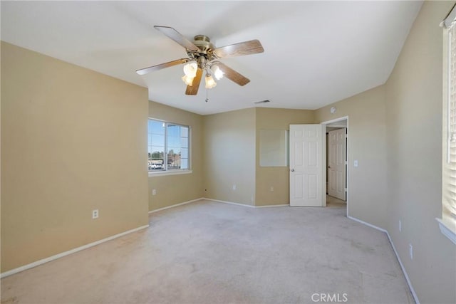 unfurnished bedroom featuring visible vents, ceiling fan, light carpet, and baseboards