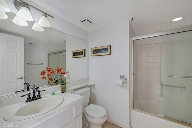 full bathroom featuring toilet, vanity, and bath / shower combo with glass door