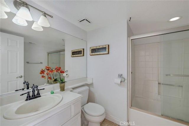 bathroom featuring visible vents, vanity, toilet, and bath / shower combo with glass door