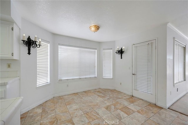 unfurnished dining area with a textured ceiling