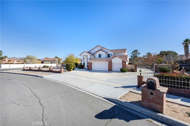 view of front of house featuring driveway, a tile roof, fence, and an attached garage