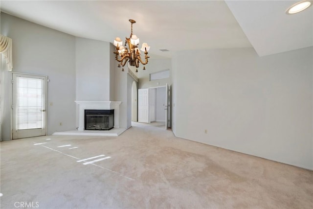 unfurnished living room featuring light colored carpet and a notable chandelier