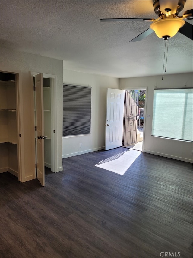 unfurnished room featuring ceiling fan, a textured ceiling, and dark hardwood / wood-style flooring