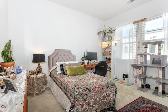 bedroom featuring light carpet