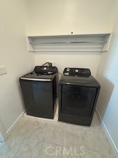 washroom featuring separate washer and dryer and light tile patterned flooring