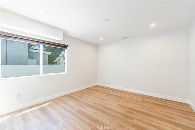 spare room featuring light hardwood / wood-style floors