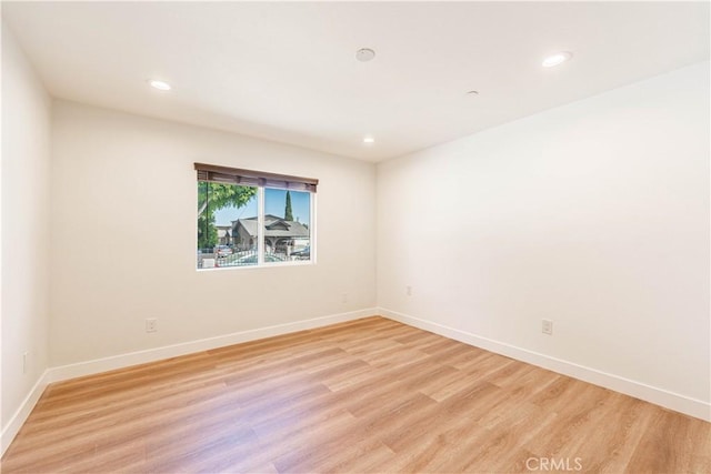 spare room featuring light hardwood / wood-style floors