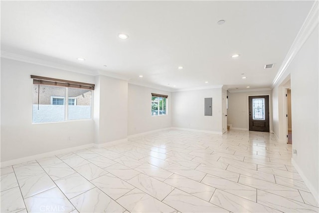 empty room with electric panel, plenty of natural light, and ornamental molding