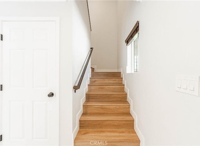 stairs featuring hardwood / wood-style flooring