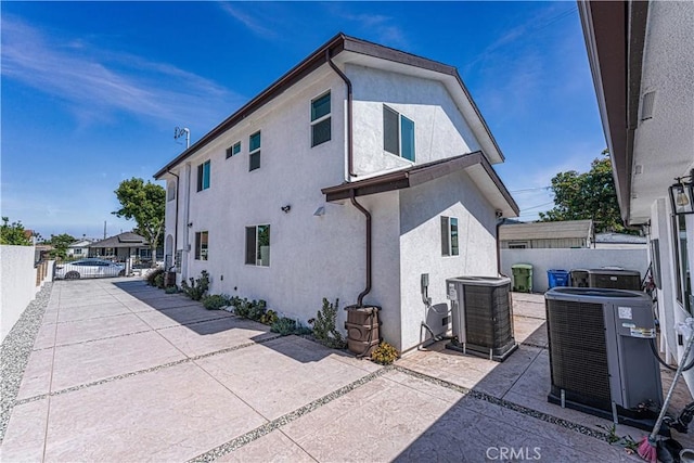 view of home's exterior featuring cooling unit and a patio area