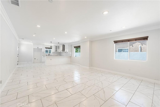 unfurnished living room featuring ornamental molding