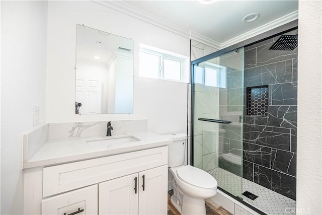 bathroom featuring crown molding, wood-type flooring, toilet, a shower with door, and vanity