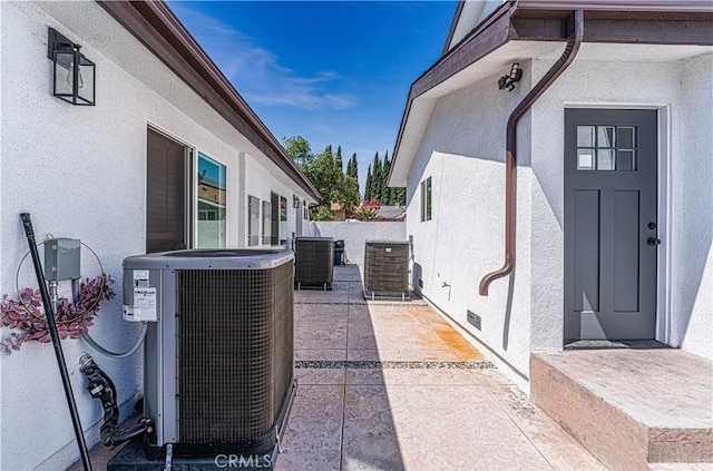 view of property exterior featuring central AC unit and a patio