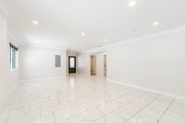 empty room featuring electric panel, a wealth of natural light, and crown molding