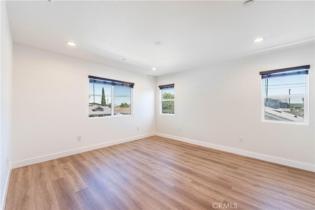 unfurnished room featuring light hardwood / wood-style floors