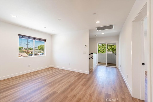 unfurnished room featuring light hardwood / wood-style flooring and a healthy amount of sunlight