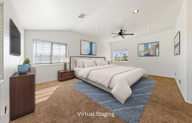 bedroom with lofted ceiling, light colored carpet, and ceiling fan