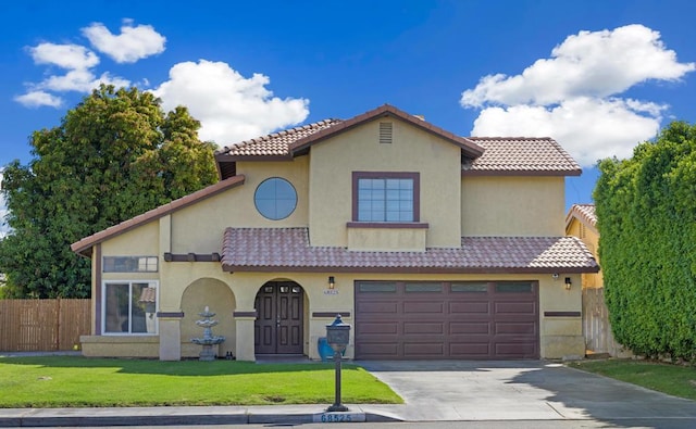 mediterranean / spanish-style home featuring a garage and a front lawn