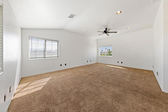 unfurnished room featuring carpet floors, vaulted ceiling, and ceiling fan