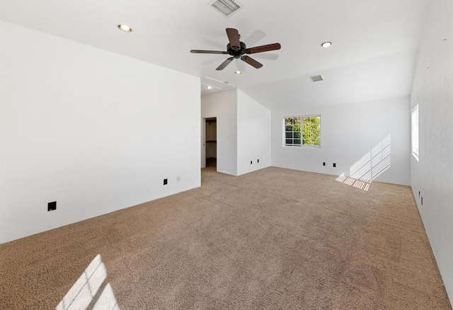 unfurnished living room featuring vaulted ceiling, light carpet, and ceiling fan