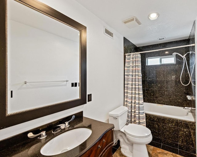 full bathroom with vanity, shower / bath combination with curtain, and toilet