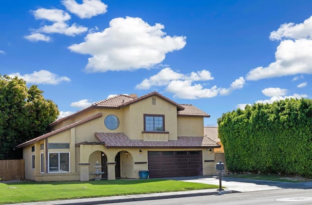 mediterranean / spanish-style house with a garage and a front yard