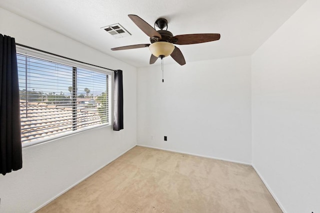 empty room with ceiling fan and light colored carpet