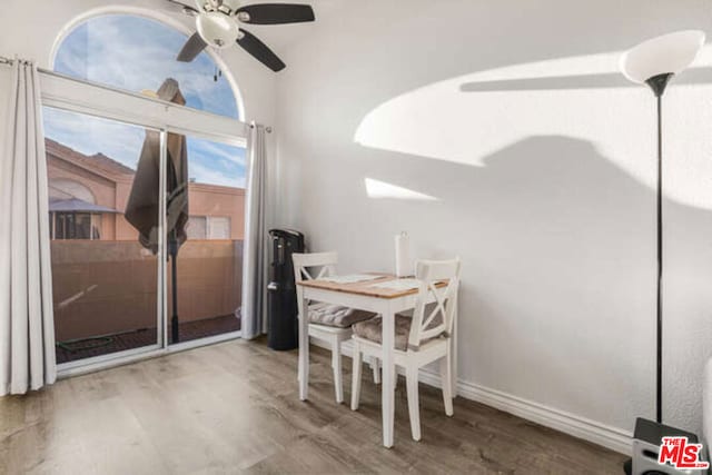 dining space with ceiling fan and wood-type flooring