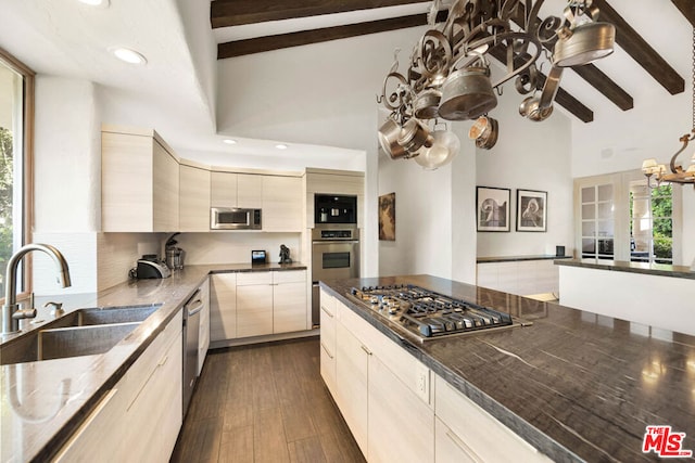 kitchen with beamed ceiling, plenty of natural light, and sink