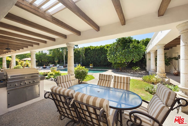 view of patio with a fenced in pool, area for grilling, ceiling fan, and exterior kitchen