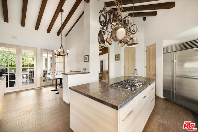 kitchen with a center island, high vaulted ceiling, and appliances with stainless steel finishes