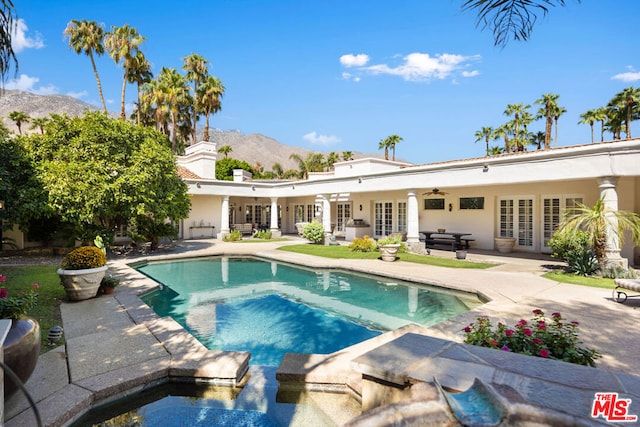 view of pool featuring a mountain view, french doors, ceiling fan, an in ground hot tub, and a patio area