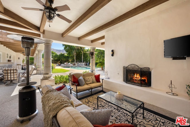 view of patio featuring an outdoor living space with a fireplace and ceiling fan