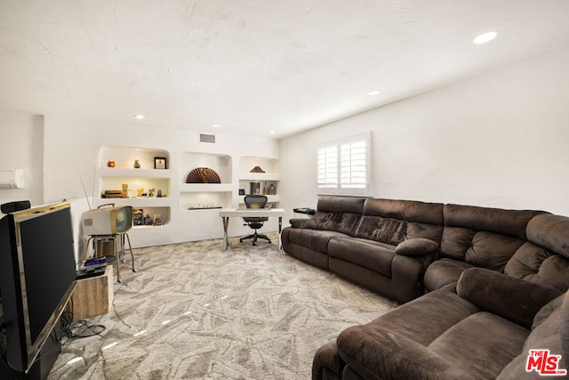 carpeted living room featuring built in features