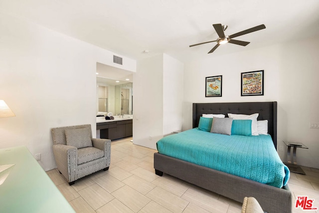 bedroom with ensuite bath, ceiling fan, and sink