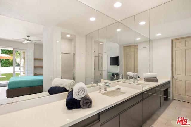 bathroom with ceiling fan, wood-type flooring, a shower with door, and vanity