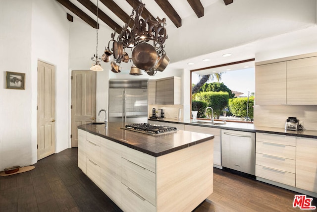 kitchen with a center island, stainless steel appliances, dark hardwood / wood-style floors, and sink