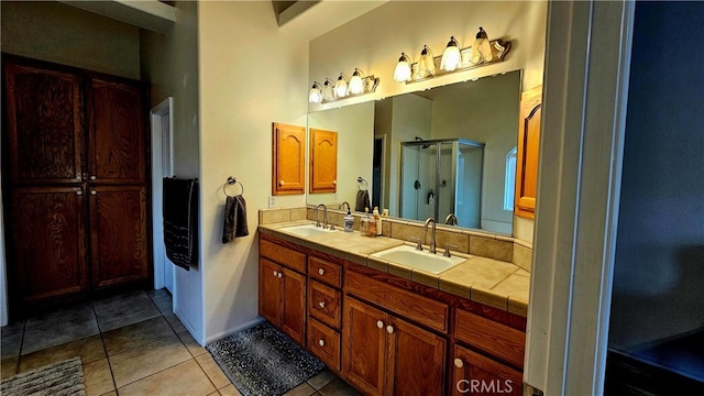 bathroom with tile patterned flooring, a shower with shower door, and vanity