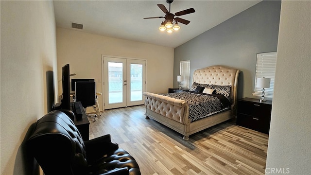 bedroom with lofted ceiling, ceiling fan, french doors, access to outside, and light hardwood / wood-style flooring