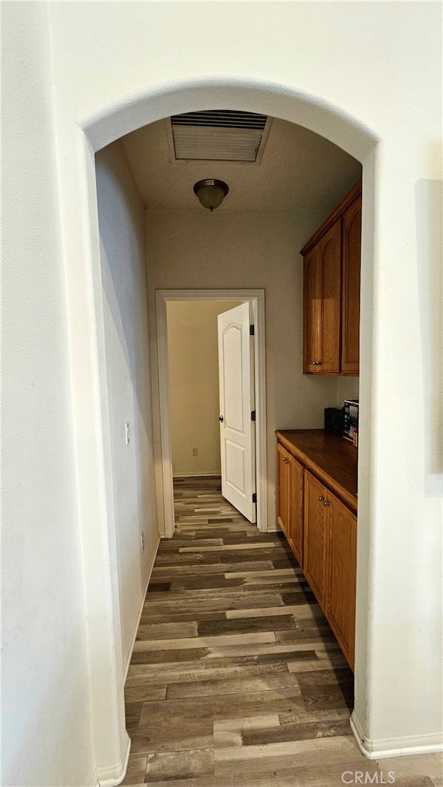 corridor featuring dark hardwood / wood-style floors