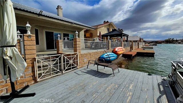 exterior space with a water view and a boat dock