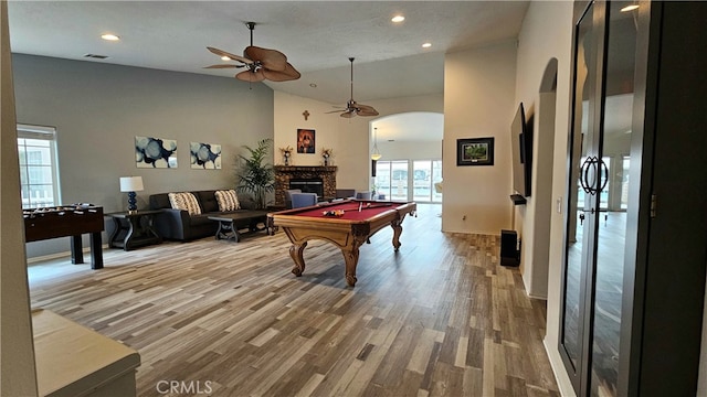 playroom featuring billiards, hardwood / wood-style floors, and a high ceiling