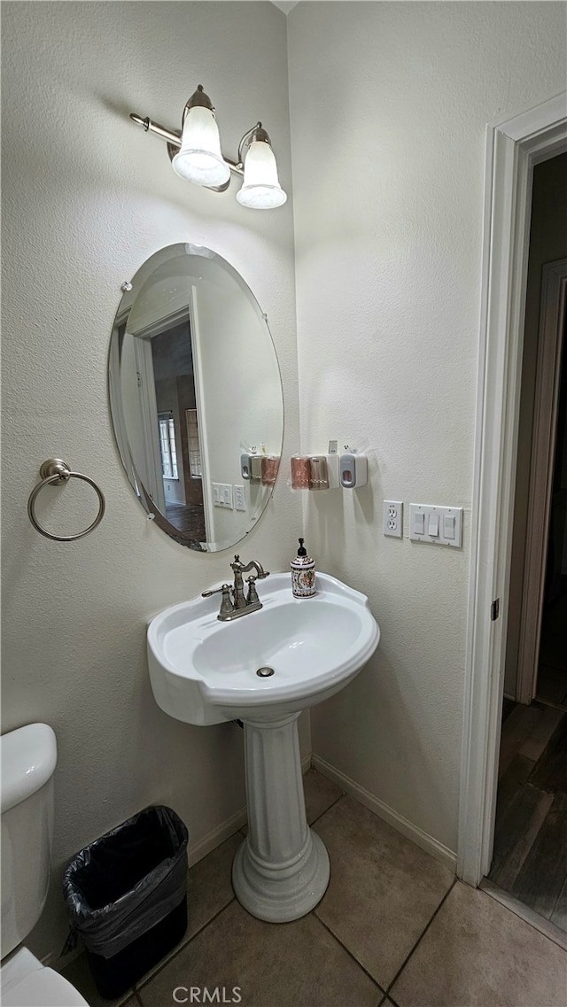 bathroom with tile patterned floors and toilet