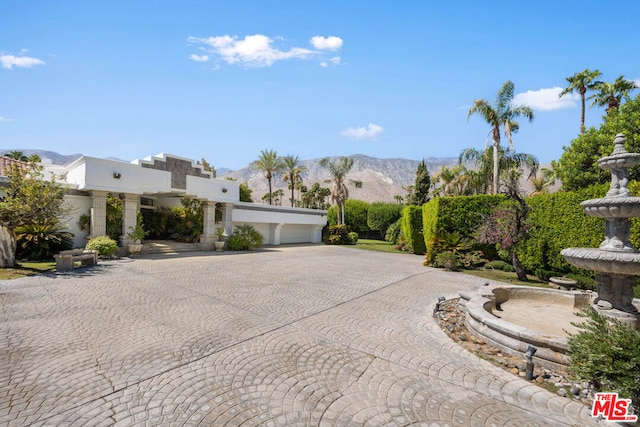 view of front of property featuring a mountain view and a garage