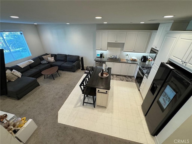 living room featuring recessed lighting and light colored carpet